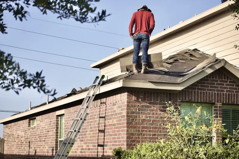 Professional roofer working on a residential roof in Ponset